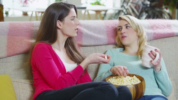 Jovens namoradas fofocando juntos enquanto relaxam em casa — Vídeo de Stock