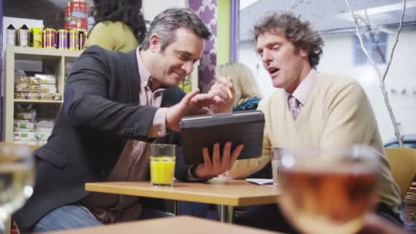 Two cheerful businessmen in casual meeting in a cafe — Stock Video