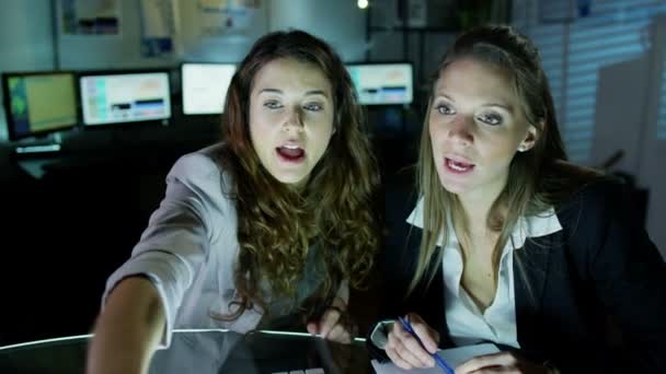 Duas mulheres de negócios bonitas trabalhando até tarde da noite — Vídeo de Stock