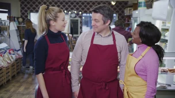 Portrait of happy male and female workers in a cafe or grocery store — Stock Video