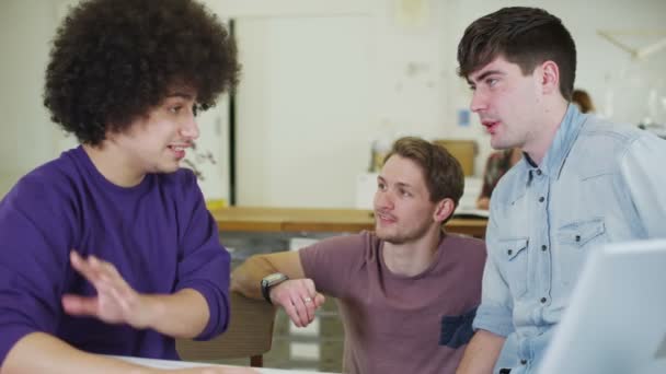 Jovens estudantes do sexo masculino conversando e trabalhando em conjunto com a tecnologia — Vídeo de Stock