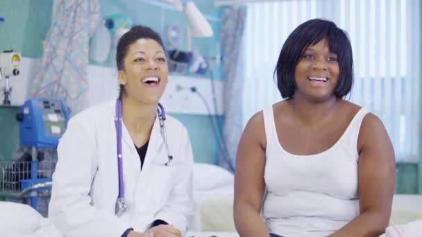 Female doctor uses a stethoscope to examine cute little girl in hospital. — Stock Video