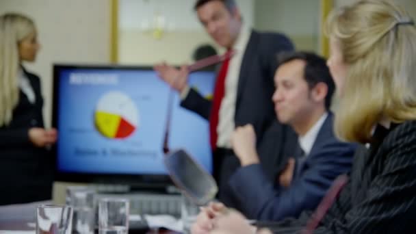 Business people seated around conference table — Stock Video