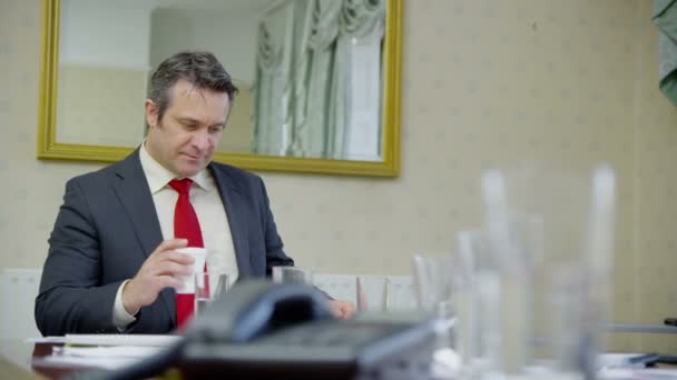 Professional man sitting in elegant office — Stock Video