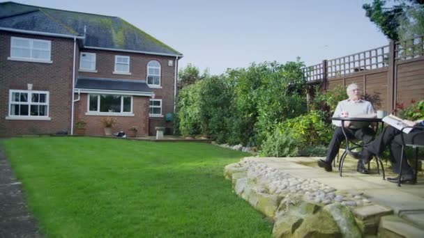 Couple sitting in garden — Stock Video