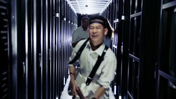 IT engineers rocking out in a data center — Stock Video