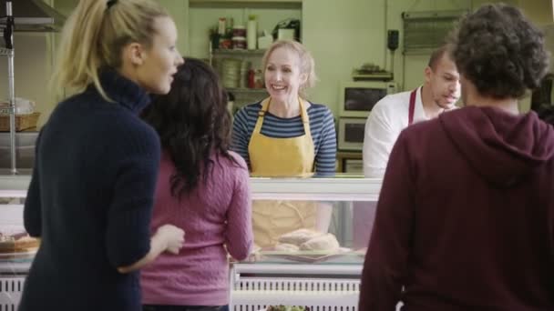 Personal amable que atiende a los clientes con una sonrisa en el mostrador de la panadería — Vídeos de Stock