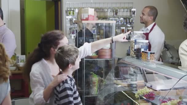 진미를 넣은 치이 즈 판매대에서 손님을 대접하는 우정적 인 직원들 — 비디오