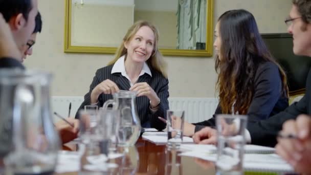 Profesionales sentados alrededor de la mesa de conferencias — Vídeos de Stock