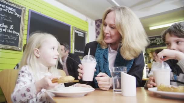 Feliz familia cariñosa disfrutando de aperitivos y bebidas en un café — Vídeos de Stock