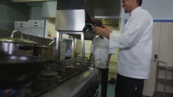 Delicious gourmet burger is prepared by the chef and taken away by the waitress — Stock Video