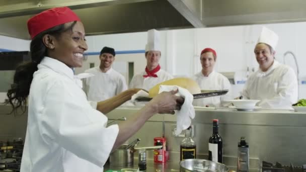 Young female chef holding a tray of freshly baked bread — Stock Video