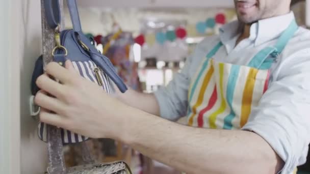 Shopkeeper is attending to merchandise in store — Stock Video