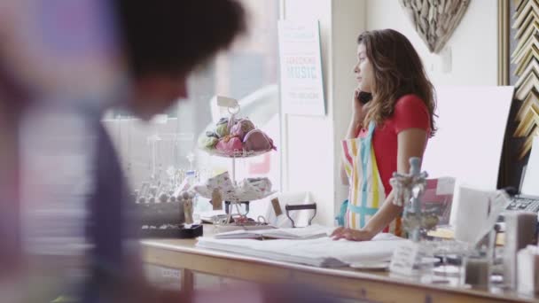 Winkeleigenaar maakt telefoongesprek op het werk — Stockvideo