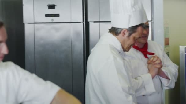 Gelukkig stagiair chef-kok werken in een professionele keuken — Stockvideo