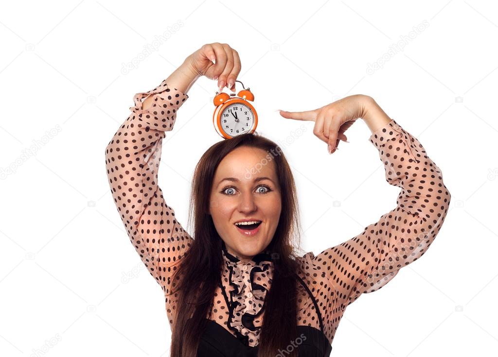 Young woman holding a clock on her head