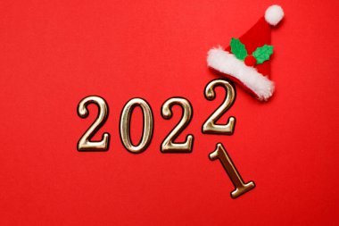 Mutlu Noeller kırmızı arka plan ve altın numaralar 2022. Yeni yıl kart dekorasyonu kavramı, metin için yeri olan üst görünüm.