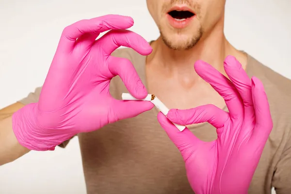 Close Man Hands Pink Medical Gloves Braking Cigarette White Background — Stock Photo, Image