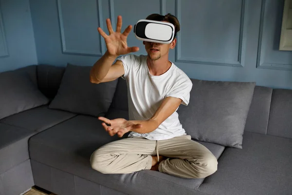 Young Man Wearing Virtual Reality Goggles Modern Coworking Interior Sitting — стоковое фото