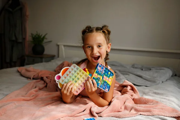 Little Cheerful Girl Plays Multi Colored Plastic Toy Pop While — Stockfoto