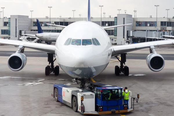 An airplane at the airport on the tarmac