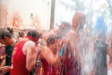 Bunol, Spain - August 28: Young people having fun on Tomatina fe clipart