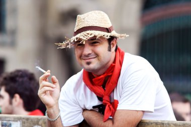 PAMPLONA, SPAIN - JULY 9: Man with a cigarette await start of ra clipart