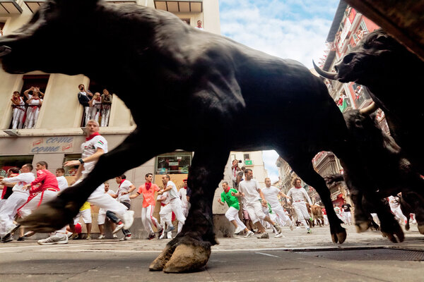 PAMPLONA, SPAIN-JULY 13: Bulls and people are running in street