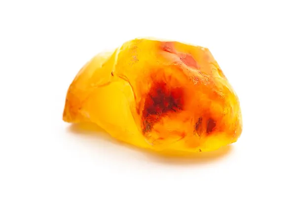 Natural amber. A piece of yellow opaque natural amber on white background. — Stock Photo, Image