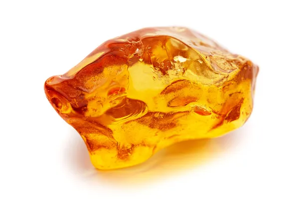 Natural amber. A piece of yellow opaque natural amber on white background. — Stock Photo, Image