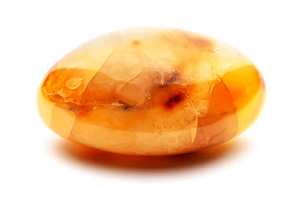 Natural amber. A piece of yellow opaque natural amber on white background. — Stock Photo, Image