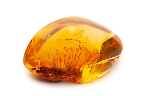 Ambre naturel. Un morceau d'ambre naturel jaune opaque sur fond blanc. — Photo