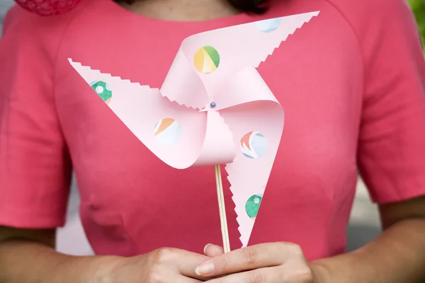 The girl in a pink dress holding a windmill — Stock Photo, Image