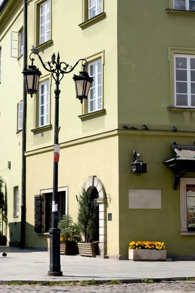 Refurbished fragment of ancient buildings in Warsaw and lantern — Stock Photo, Image