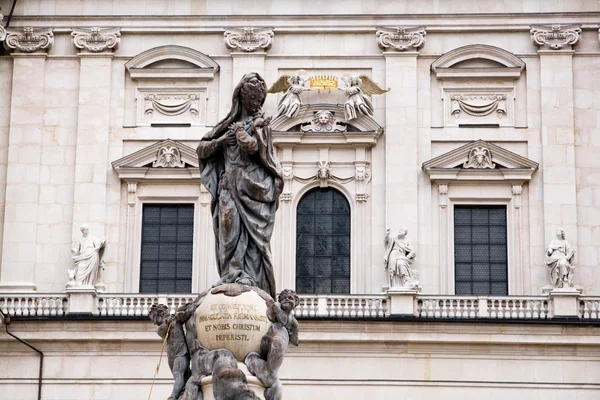 A fragment of a white church and the statue in the foreground — Stock Photo, Image