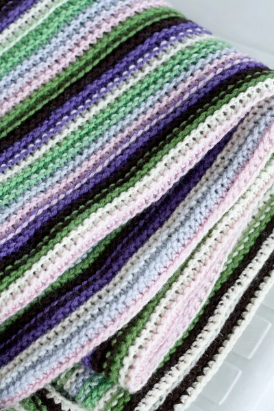 Knitting striped rug with white, purple, green and pink stripes — Stock Photo, Image