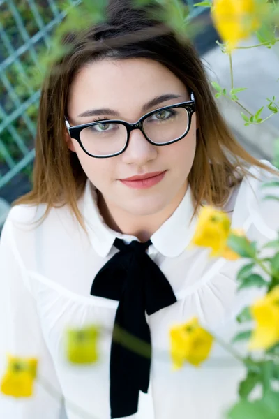 Portrait of a young beautiful girl in black glasses — Stock Photo, Image