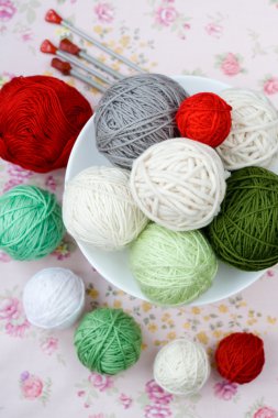 A lot of bright balls of knitting on the background clipart