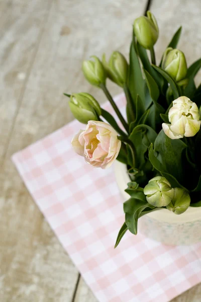 Bouquet of delicate pink tulips on the tablecloth — Stock Photo, Image