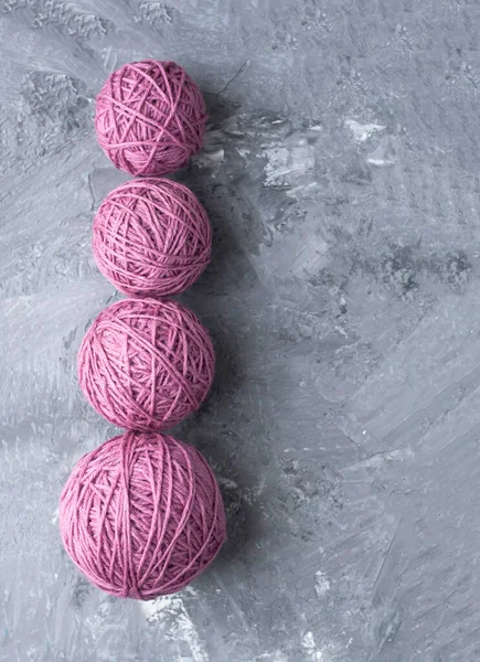 Four Different Size Pink Balls Yarn Grey Background — стоковое фото