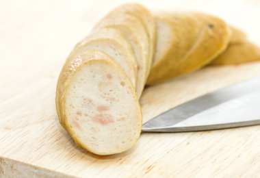  sosis kesme tahtası üzerinde bıçak ile