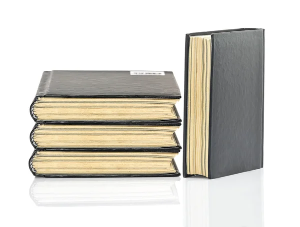 Black hardcover book on white glossy background — Stock Photo, Image