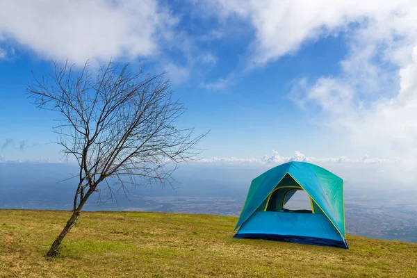 朝は白い雲と青い空の下で草の上にテントキャンプ — ストック写真