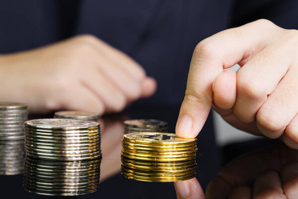 Close-up of finger touching golden bitcoin coin. Cryptocurrency and future money concept