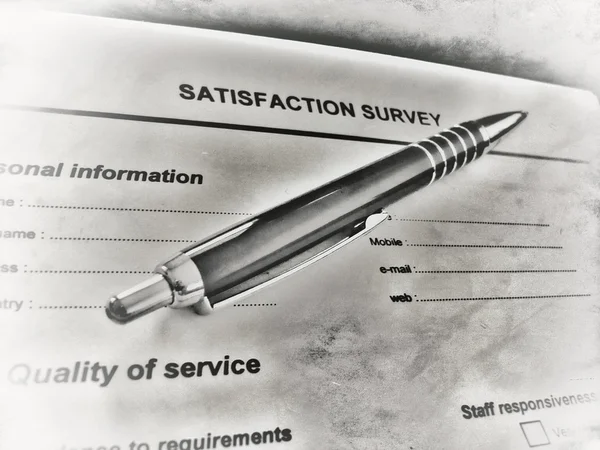 Pen laying on a customer satisfaction form Royalty Free Stock Images