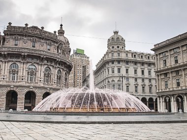 The fountain in Piazza De Ferrari in Genoa squirts water pink clipart