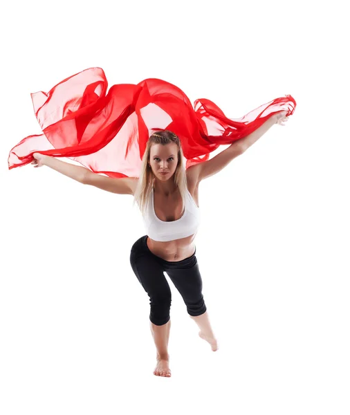 Vrouw in yoga pose en geel vliegen stof — Stockfoto