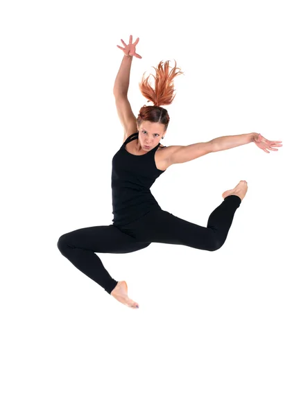 Young woman doing perfect jump in black costume Stock Image