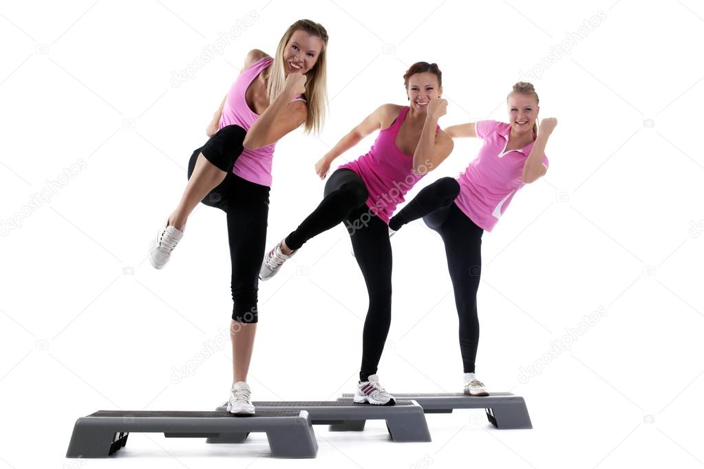 Young group women training on stepper isolated