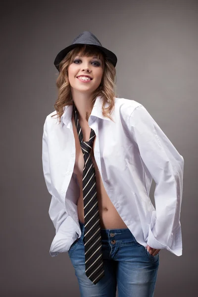 Young girl smile in white shirt during striptease — Stock Photo, Image